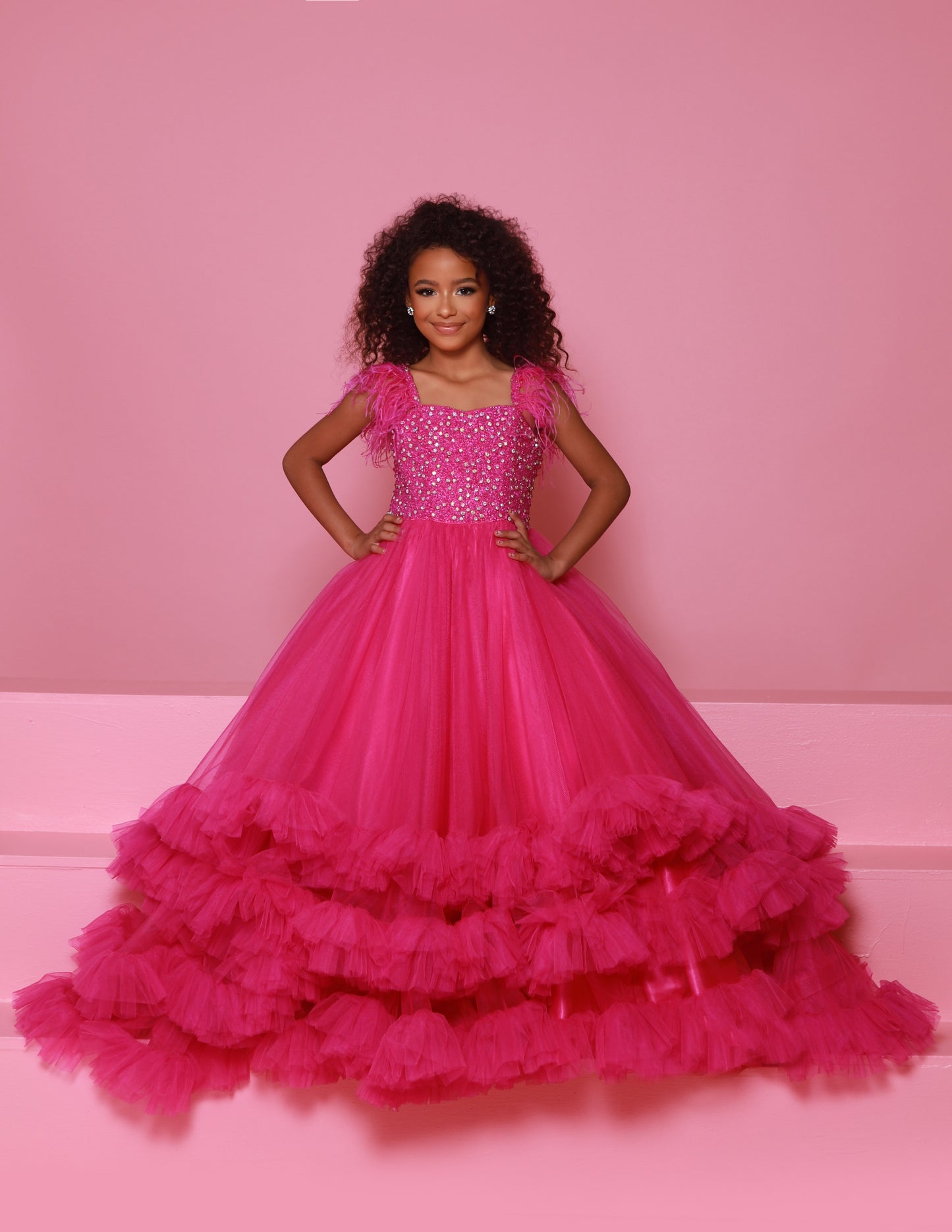 Sugar Kayne C327 features a fashionable pageant dress for girls and preteens, complete with feather straps, a tiered ruffle bottom, and a crystal stone bodice.&nbsp;Stand out and feel confident on stage! This tulle ballgown features ostrich feathers on the shoulders, a beaded bodice, and tiered skirt to show off your personality!

Colors:&nbsp; Aqua, Bubblegum, White, Magenta

Sizes:&nbsp;&nbsp;2, 4, 6, 8, 10, 12, 14, 16

(Sizes 2-6 do not have bust cups, Sizes 8-16 will have preteen size bust cups)