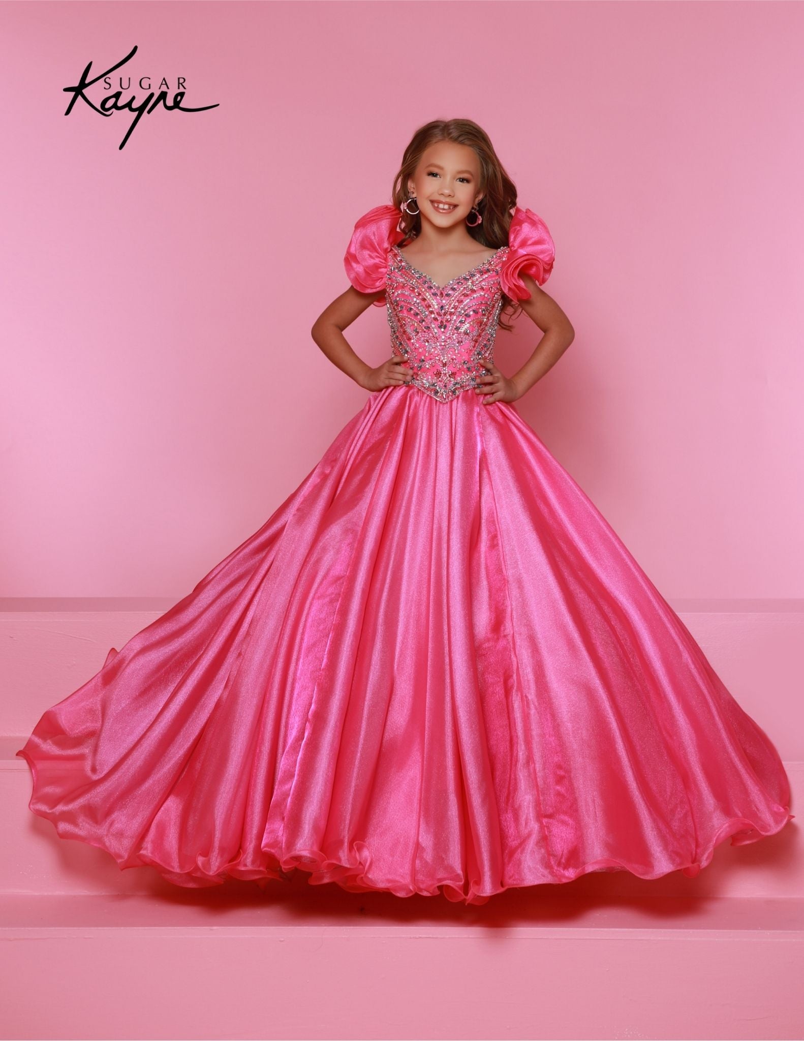 Bring out her inner beauty with this Sugar Kayne C334 Girls Pageant Dress. This luxurious dress is made from iridescent organza and features a sweetheart neckline and long ball gown skirt. Perfect for any special occasion.&nbsp;Transform into a twinkling starlet with this Metallic Organza Gown. The beaded bodice adds a touch of sparkle to this enchanting ensemble. The delicate ruffle sleeves create a charming look!

Color:&nbsp;Hot Pink Multi, Mint Multi, White Multi, Purple Multi

Size:&nbsp;2, 4, 6, 8, 10