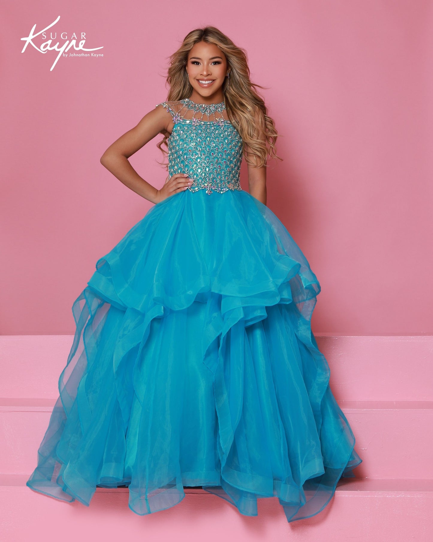 Sugar Kayne C354&nbsp; This high-quality girls' pageant ballgown from Sugar Kayne boasts an embellished bodice, a high crystal neckline, and a layered organza long skirt with horsehair trim. Perfect for making a statement on stage, this dress exudes elegance and sophistication. Walk with confidence and grace in this stunning piece.

Colors:&nbsp; Barbie Pink, Daffodil, Jade, Turquoise

Sizes:&nbsp; 2-16