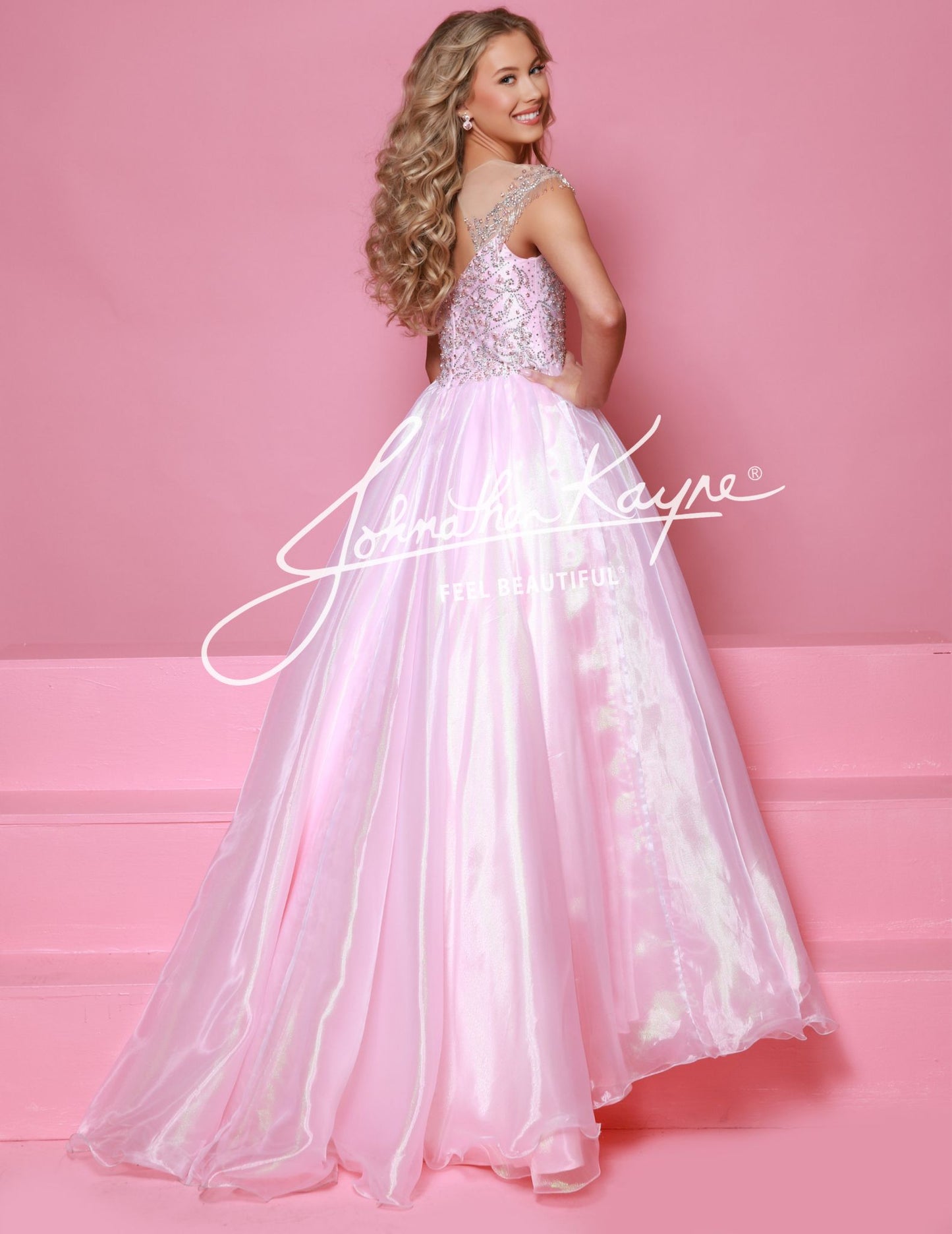 Get ready to dazzle in this Sugar Kayne C357 girls organza ballgown! With an off the shoulder design, long wire hem skirt, and crystal bodice, this dress is fit for a princess. The perfect combination of beauty and elegance, this gown will make you stand out at any special occasion. This Sugar Kayne C357 Girls Pageant Dress is a stunning ballgown that will make your little girl stand out on stage. The off the shoulder design and fringe detailing add a touch of glamour, while the shimmer fabric gives the dre