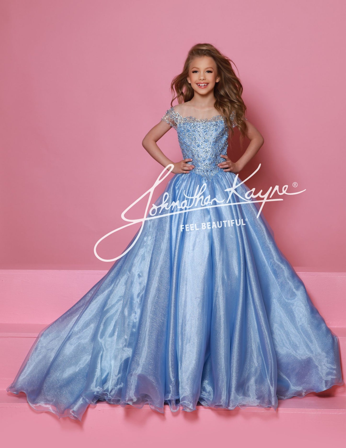 Get ready to dazzle in this Sugar Kayne C357 girls organza ballgown! With an off the shoulder design, long wire hem skirt, and crystal bodice, this dress is fit for a princess. The perfect combination of beauty and elegance, this gown will make you stand out at any special occasion. This Sugar Kayne C357 Girls Pageant Dress is a stunning ballgown that will make your little girl stand out on stage. The off the shoulder design and fringe detailing add a touch of glamour, while the shimmer fabric gives the dre