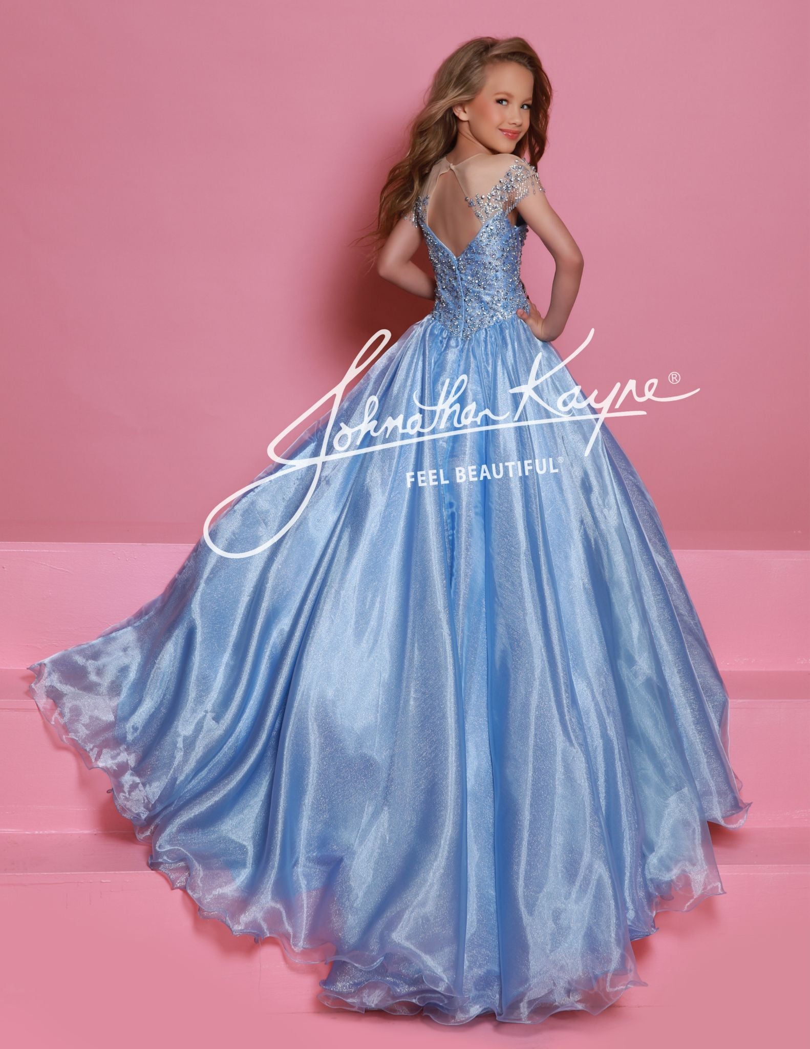 Get ready to dazzle in this Sugar Kayne C357 girls organza ballgown! With an off the shoulder design, long wire hem skirt, and crystal bodice, this dress is fit for a princess. The perfect combination of beauty and elegance, this gown will make you stand out at any special occasion. This Sugar Kayne C357 Girls Pageant Dress is a stunning ballgown that will make your little girl stand out on stage. The off the shoulder design and fringe detailing add a touch of glamour, while the shimmer fabric gives the dre