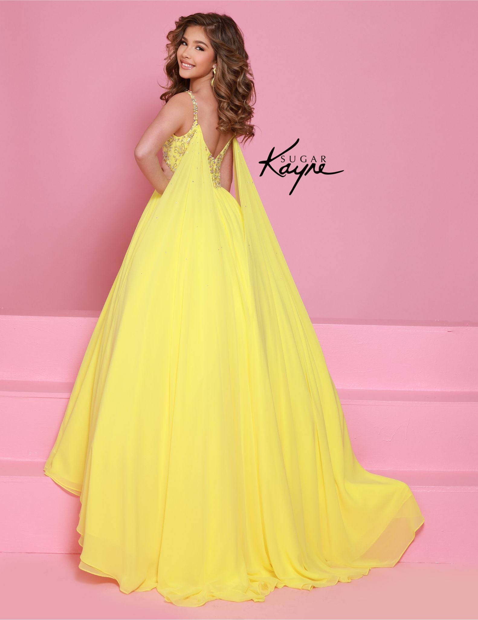 Experience the epitome of grace and sophistication with the Sugar Kayne C368 Chiffon Cape Girls Pageant Dress. Adorned with delicate crystal sequins and a stunning bodice, this ballgown is sure to make a lasting impression. The chiffon cape adds a touch of elegance and the perfect finishing touch. Perfect for teenagers looking for a show-stopping dress. Be simply stunning at your next pageant in this exquisite poly chiffon dress. Designed with beaded straps and a bodice that exudes winner-worthy elegance, i