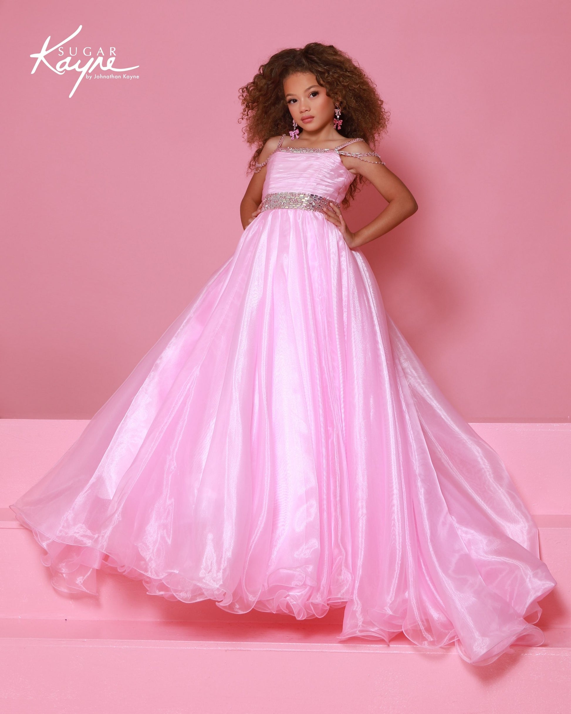 Designer: SugaDesigner: Sugar Kayne — Style C401
Sugar Kayne style C401 is a classic girls pageant dress with layered organza and a smooth satin lining for beautir Kayne — Style C401
Sugar Kayne style C401 is a classic girls pageant dress with layered organza and a smooth satin lining for beautiful volume and shine. The full skirt and refined bodice give this gown timeless pageant appeal, making it ideal for everything from local titles to national stages.

Sizes: 2–16
Colors: Cotton Candy, Jade, White/Gold