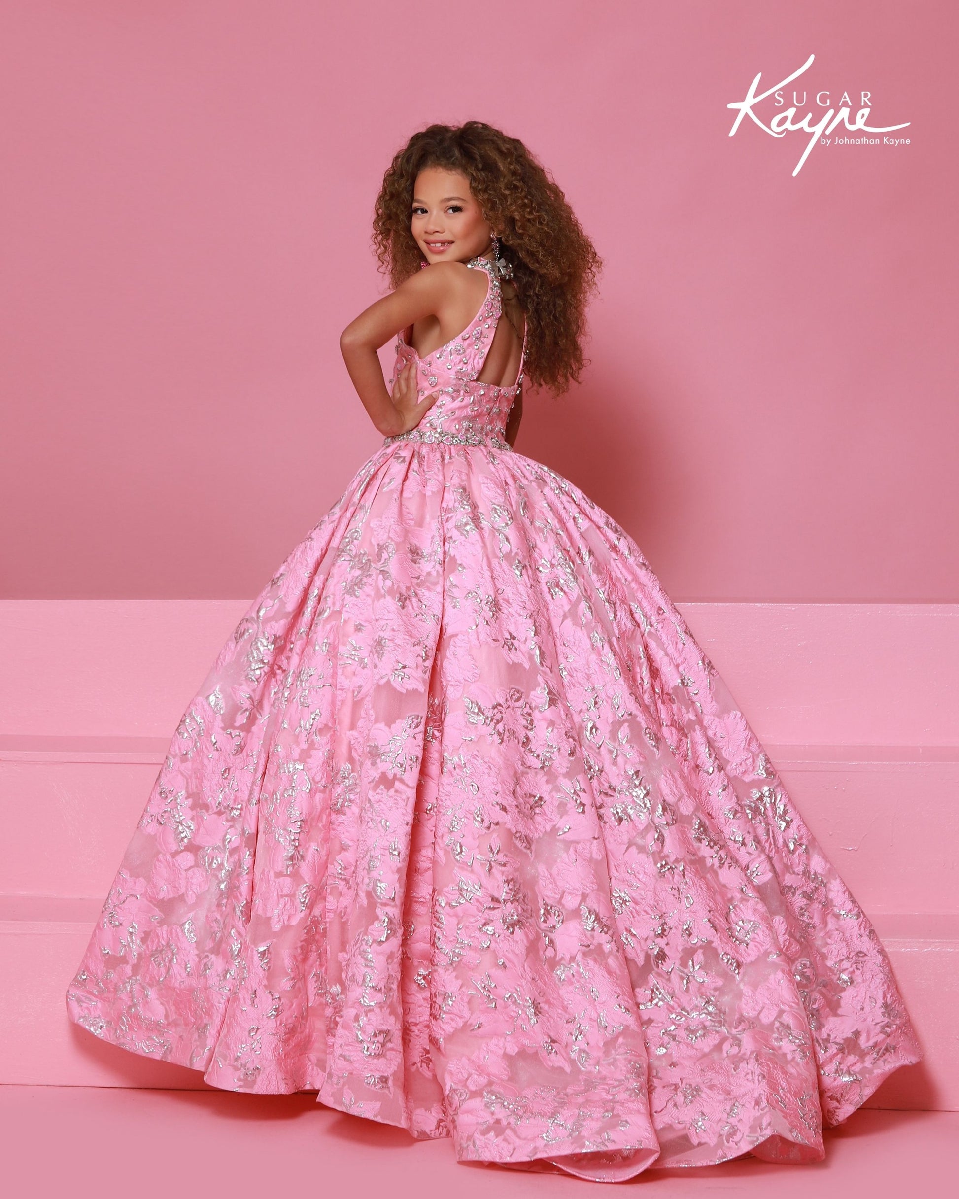 Designer: Sugar Kayne — Style C404
Sugar Kayne style C404 is a classic girls pageant dress with layered organza and a smooth satin lining for beautiful volume and shine. The full skirt and refined bodice give this gown timeless pageant appeal, making it ideal for everything from local titles to national stages.

Sizes: 2–16
Colors: Metallic Blue, Metallic Pink