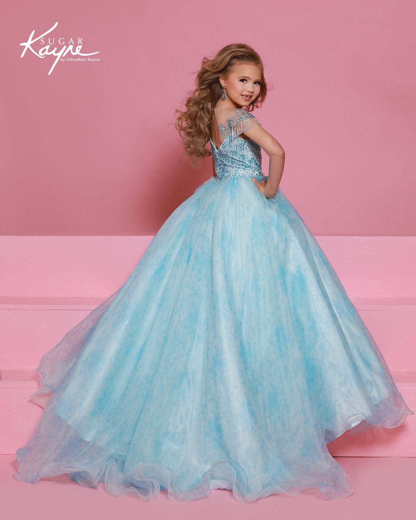 Designer: Sugar Kayne — Style C406
Sugar Kayne style C406 is a classic girls pageant dress with layered organza and a smooth satin lining for beautiful volume and shine. The full skirt and refined bodice give this gown timeless pageant appeal, making it ideal for everything from local titles to national stages.

Sizes: 2–16
Colors: Blush, Blue
