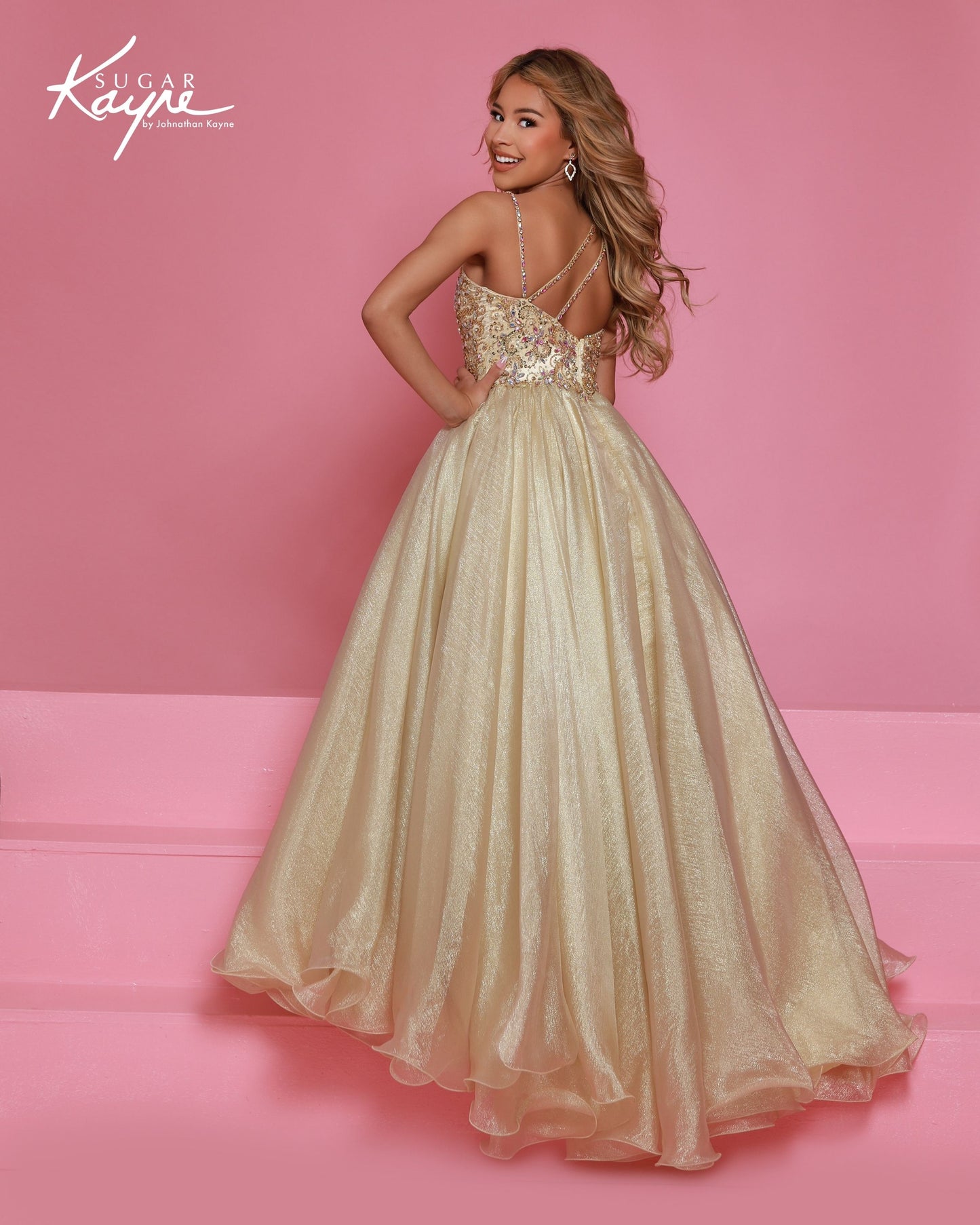 Designer: Sugar Kayne — Style C407
Sugar Kayne style C407 is a classic girls pageant dress with layered organza and a smooth satin lining for beautiful volume and shine. The full skirt and refined bodice give this gown timeless pageant appeal, making it ideal for everything from local titles to national stages.

Sizes: 2–16
Colors: Gold, Turquoise