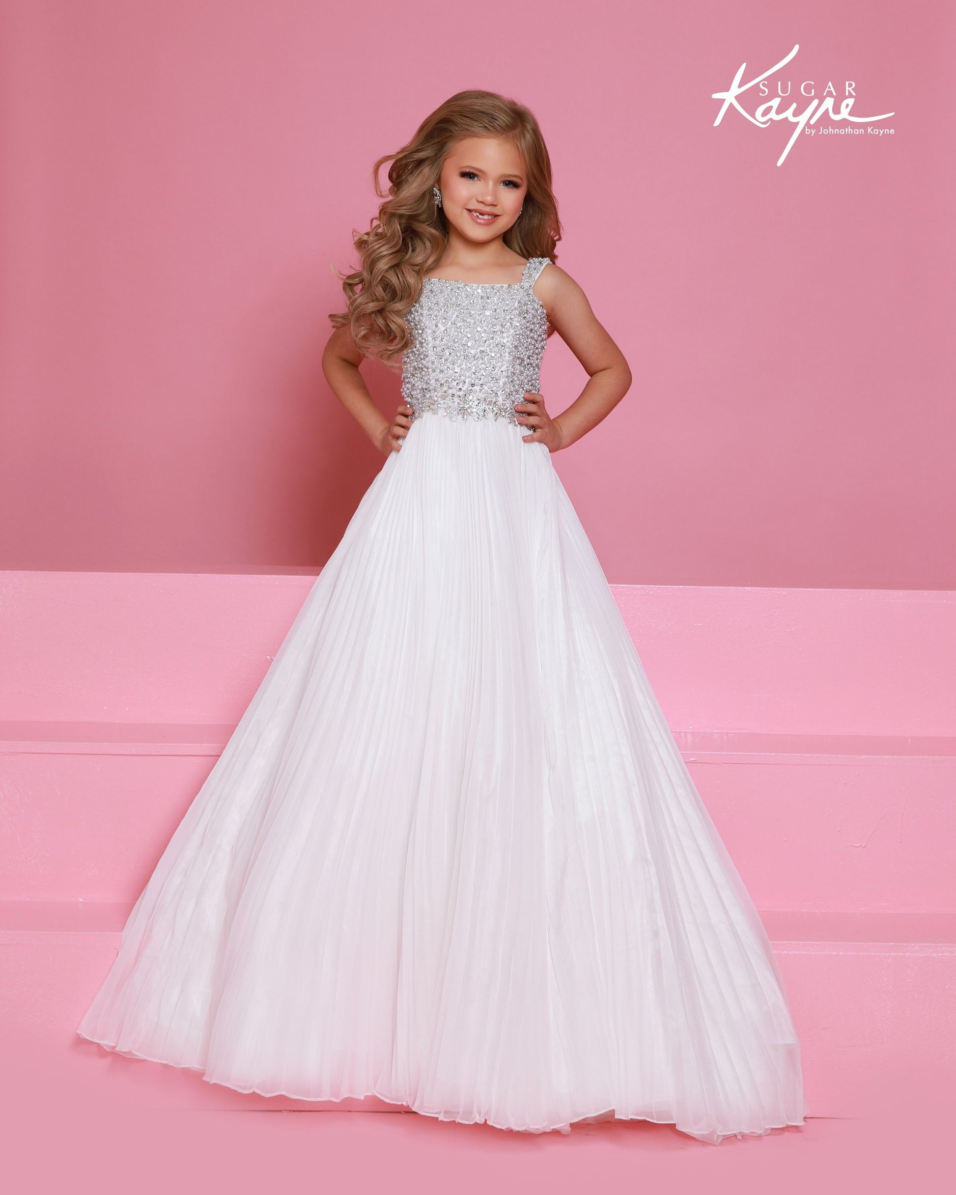 Designer: Sugar Kayne — Style C408
This lightweight Sugar Kayne girls pageant dress, style C408, showcases flowing chiffon over a satin lining for effortless drape and motion. The look is soft, feminine, and comfortable, giving her a confident presence from interview to evening wear on the pageant stage.

Sizes: 2–16
Colors: Hot Pink, Turquoise, White