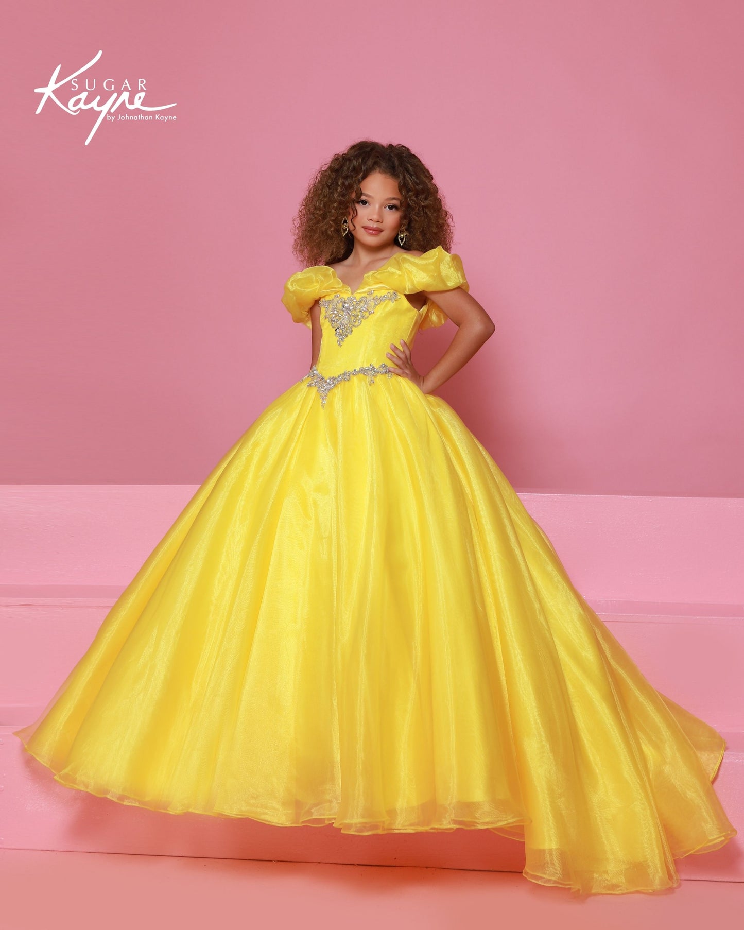Designer: Sugar Kayne — Style C410
Sugar Kayne style C410 is a classic girls pageant dress with layered organza and a smooth satin lining for beautiful volume and shine. The full skirt and refined bodice give this gown timeless pageant appeal, making it ideal for everything from local titles to national stages.

Sizes: 2–16
Colors: Canary, Neon Pink, Turquoise