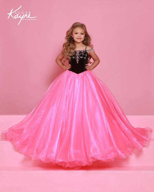 Designer: Sugar Kayne — Style C412
Elegant and rich, Sugar Kayne style C412 is a girls pageant dress that blends luxurious stretch velvet with flowing skirt details. The gown offers comfortable stretch while maintaining a refined, high-end look that stands out in formal and pageant settings.

Sizes: 2–16
Colors: Black/Pink, Black/White, White