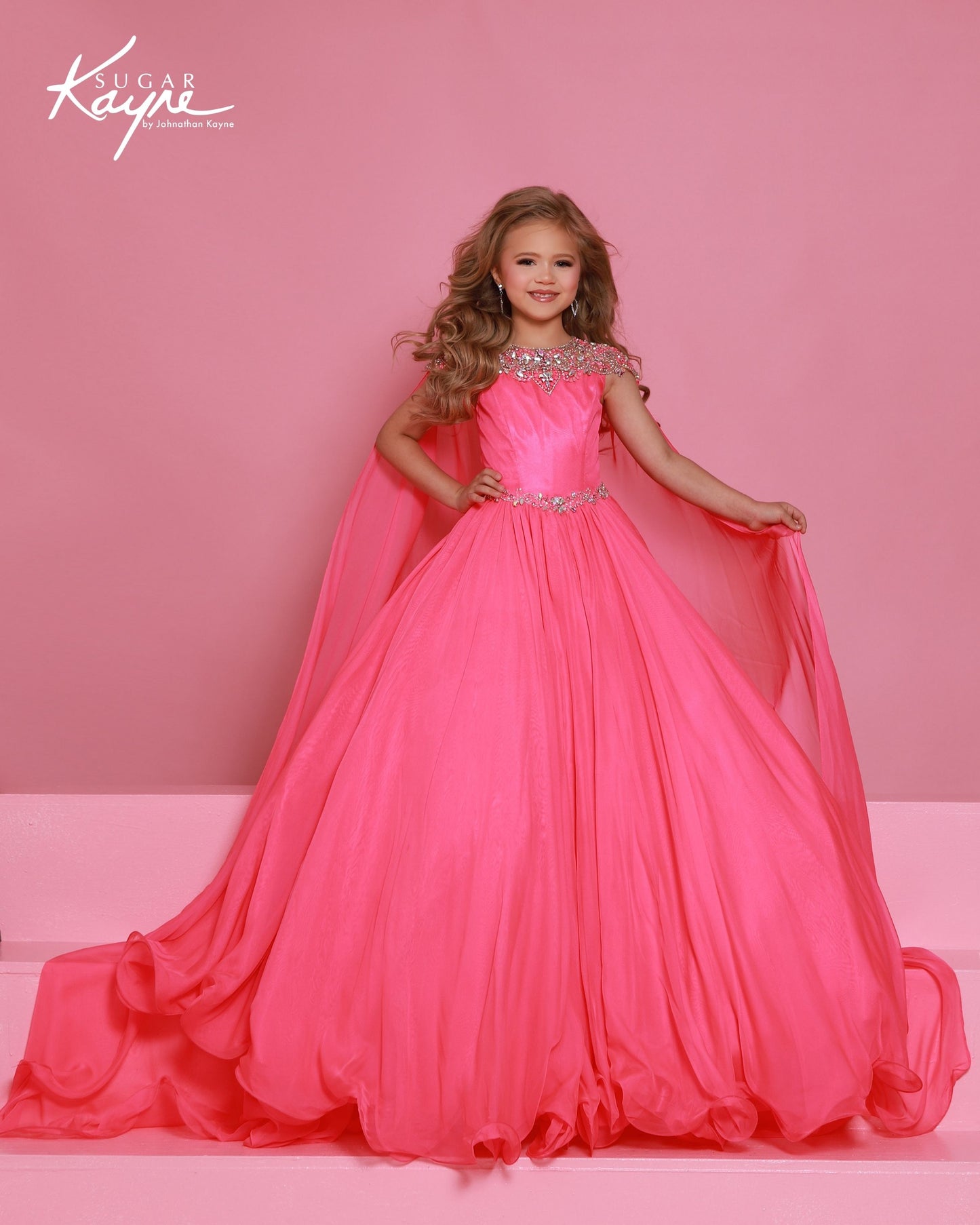 Designer: Sugar Kayne — Style C415
This lightweight Sugar Kayne girls pageant dress, style C415, showcases flowing chiffon over a satin lining for effortless drape and motion. The look is soft, feminine, and comfortable, giving her a confident presence from interview to evening wear on the pageant stage.

Sizes: 2–16
Colors: Aqua, Lemon, Neon Pink