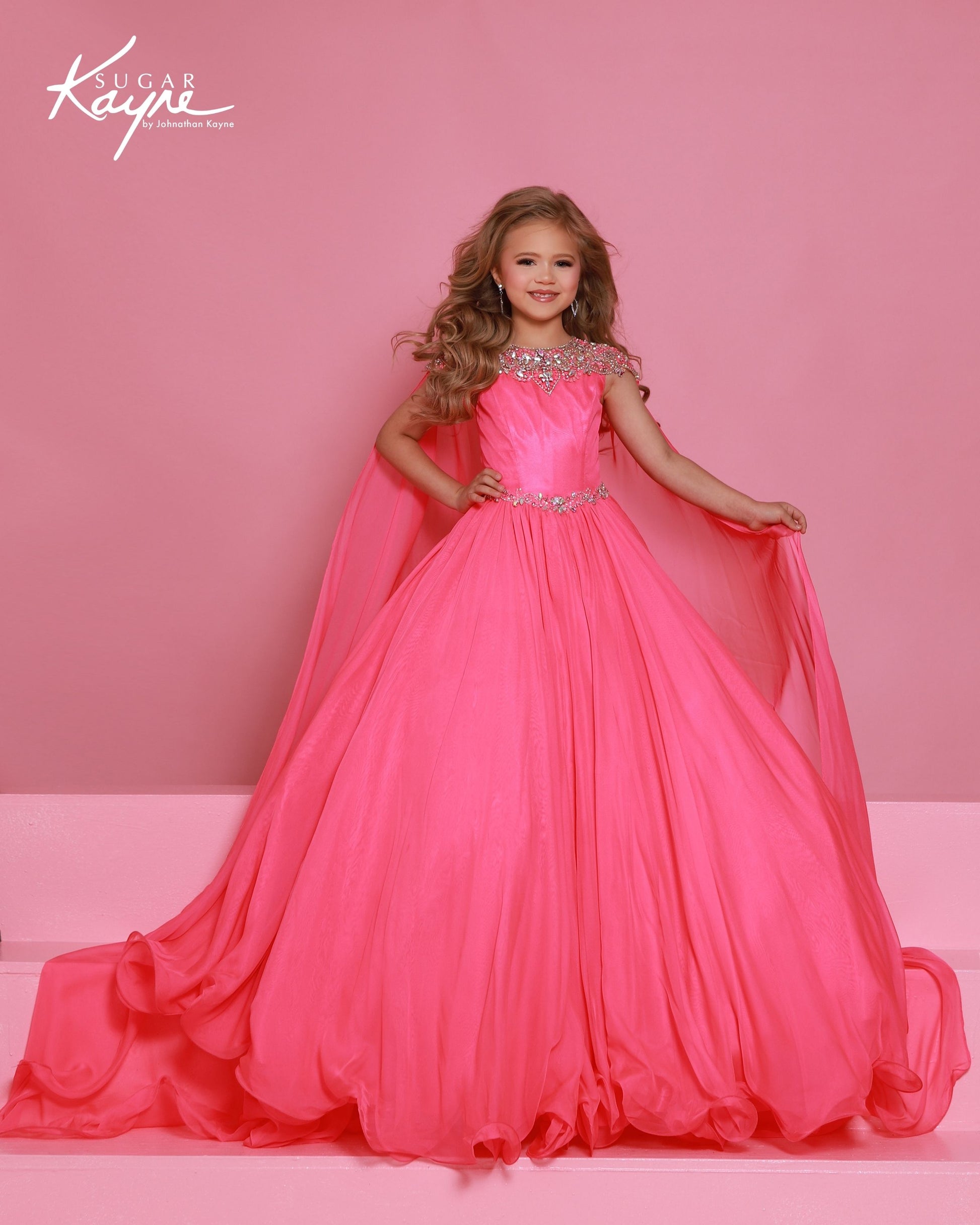 Designer: Sugar Kayne — Style C415
This lightweight Sugar Kayne girls pageant dress, style C415, showcases flowing chiffon over a satin lining for effortless drape and motion. The look is soft, feminine, and comfortable, giving her a confident presence from interview to evening wear on the pageant stage.

Sizes: 2–16
Colors: Aqua, Lemon, Neon Pink