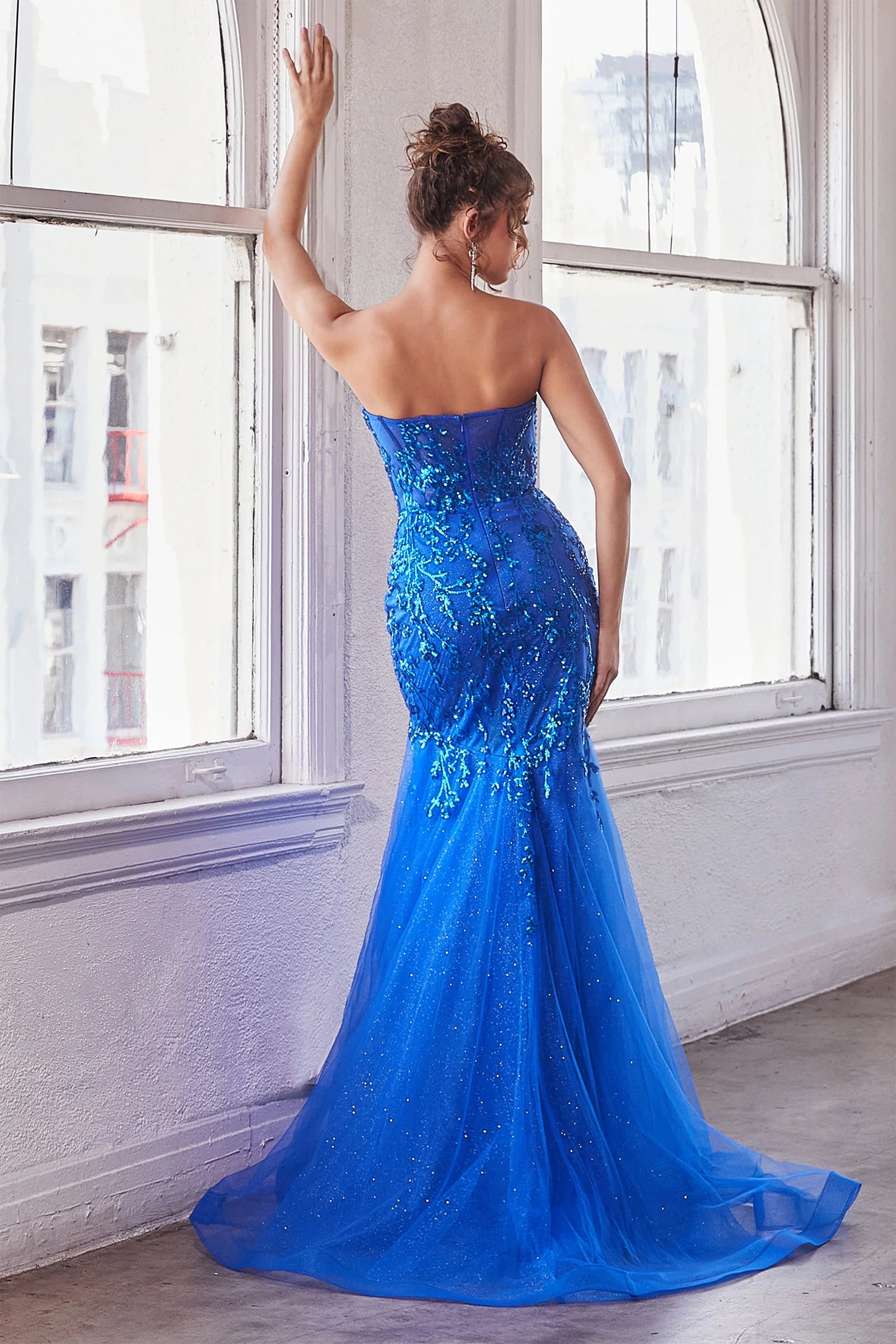 The Ladivine CB139 prom dress boasts a sheer corset bodice that adds a hint of allure to this shimmering dress. The mermaid silhouette and strapless design give a stunning, formal look that will turn heads. Perfect for prom or any special occasion. Look absolutely breathtaking in this beautiful strapless mermaid gown.