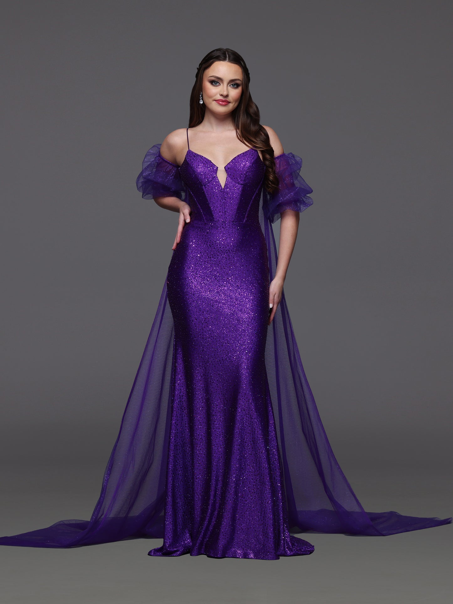 Elevate your prom look with the Candice Wang 72521 dress. This glittery fitted dress features a detachable puff sleeve cape for added drama. Stand out in style and comfort with the perfect fit and eye-catching design. Step out confidently and make a statement at your special event.

Size: 8

Color: Purple