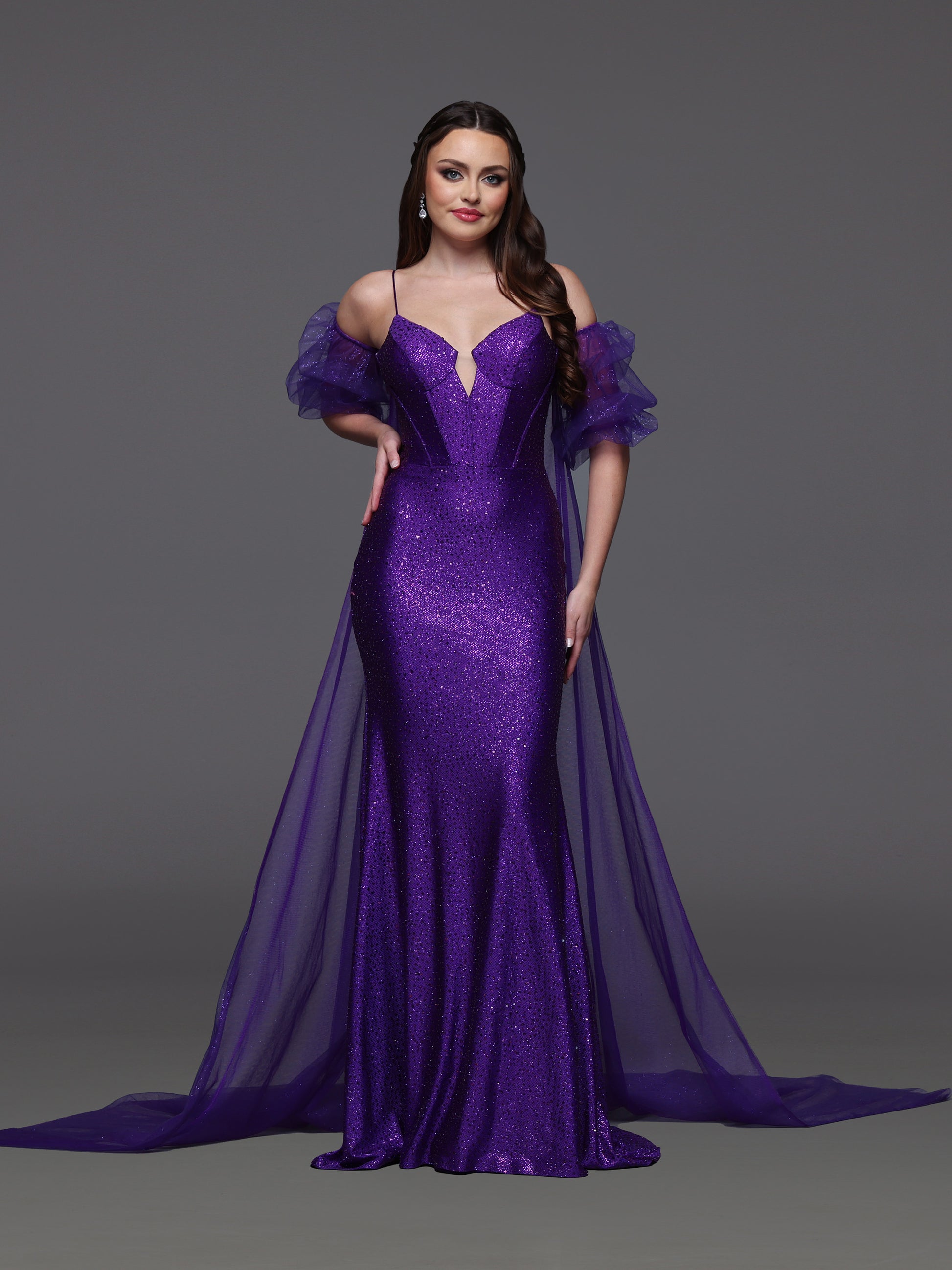 Elevate your prom look with the Candice Wang 72521 dress. This glittery fitted dress features a detachable puff sleeve cape for added drama. Stand out in style and comfort with the perfect fit and eye-catching design. Step out confidently and make a statement at your special event.

Size: 8

Color: Purple