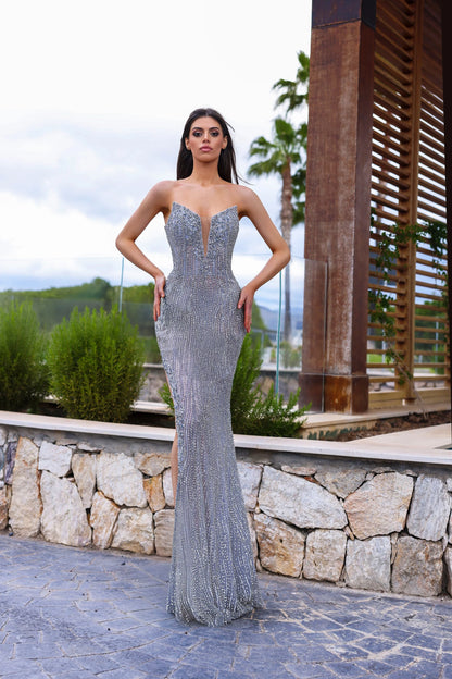 This expertly crafted Chic and Holland HF110284 gown in size 0 features a stunning silver crystal embellishment that elevates the fitted silhouette. Designed with a high slit, it offers graceful movement and a striking profile. The illusion scoop neck gracefully transitions into a V-neckline, combining elegance with modern couture appeal. Perfect for pageants or formal events, this gown balances sophistication and glamour to ensure unforgettable presence.

Size 0&nbsp;

Color: Silver