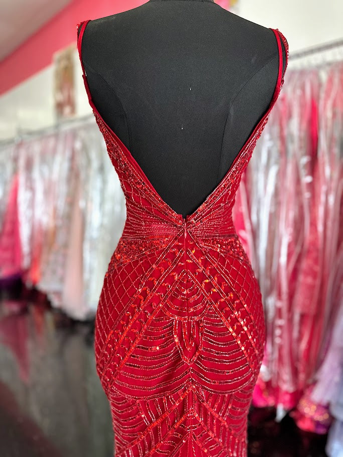 Elevate your formal occasion with the Chic and Holland AR330375 prom dress in vibrant red. This size 2 gown is adorned with intricate beadwork and shimmering sequins, creating an elegant, eye-catching silhouette. The deep V neckline and high slit skirt add a sophisticated allure, balancing modern style with timeless grace. Perfect for pageants or special events, this dress ensures you stand out with refined glamour and confident poise.

Size: 2

Color: Red