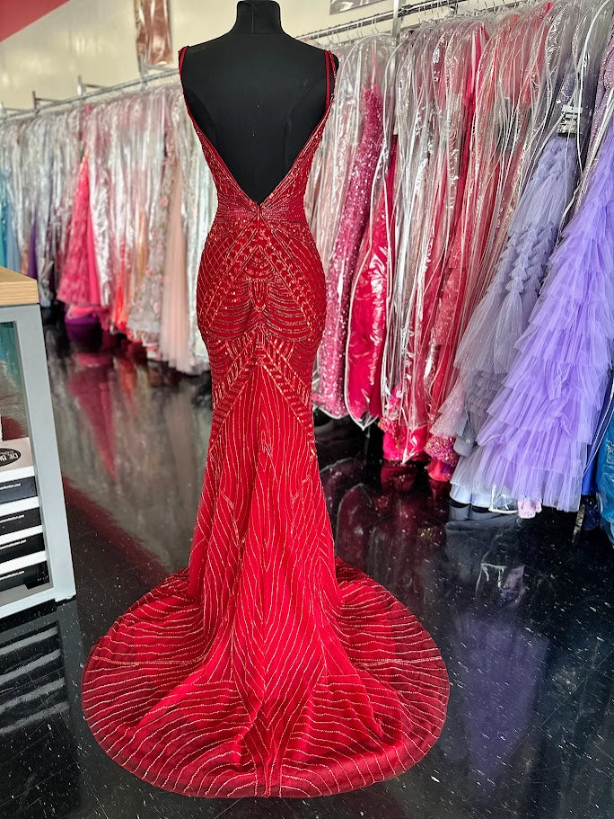 Elevate your formal occasion with the Chic and Holland AR330375 prom dress in vibrant red. This size 2 gown is adorned with intricate beadwork and shimmering sequins, creating an elegant, eye-catching silhouette. The deep V neckline and high slit skirt add a sophisticated allure, balancing modern style with timeless grace. Perfect for pageants or special events, this dress ensures you stand out with refined glamour and confident poise.

Size: 2

Color: Red