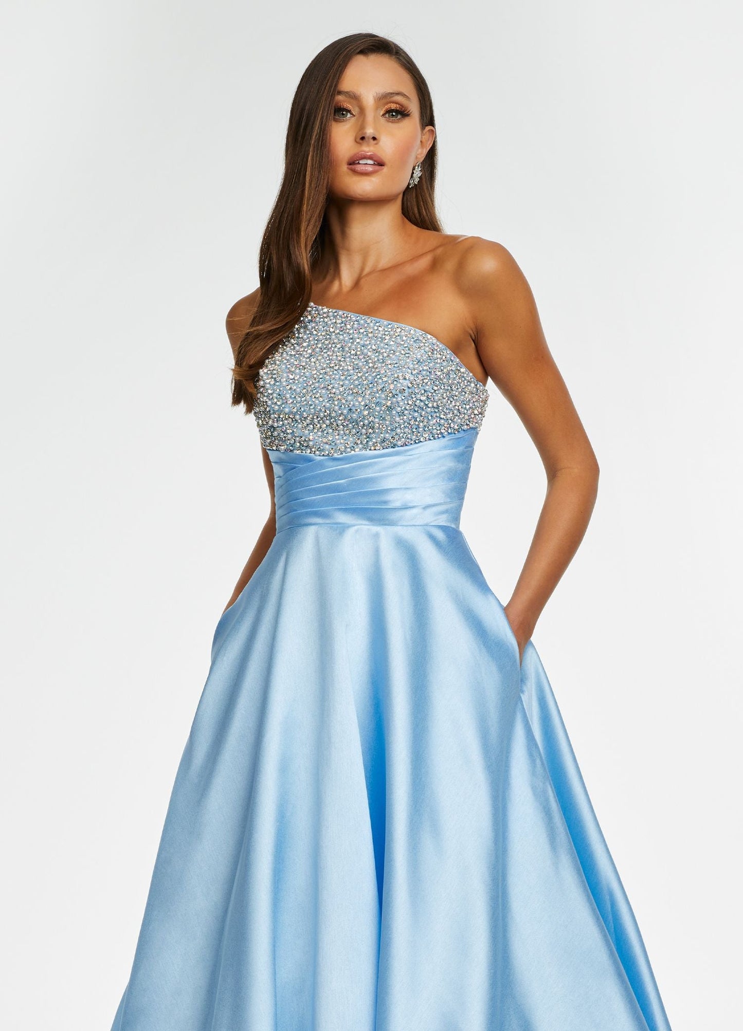 Ashley Lauren 11149 One Shoulder Ball Gown Prom Dress with Embellished Bodice  Sparkle in this one shoulder taffeta ball gown. The elegantly encrusted bustier is embellished with pearls and crystals that give way to wrap waistline. Did we mention is has pockets?!  One Shoulder Beaded Bustier Shimmer Taffeta Train Colors:  Sky, Aqua, Pink, White Sizes:  0-16