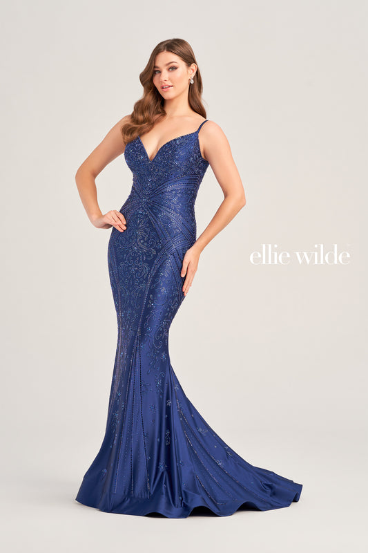 Look stunning in the Ellie Wilde EW35002 prom dress! Crafted from luxurious crystal jersey fabric, this mermaid evening gown features a corset-style bodice and a snug fit for a captivating silhouette. Decorated with shimmering Crystal accents, this dress adds sparkle and shine for an unforgettable formal look.  COLOR: BLACK, NAVY BLUE, ROYAL BLUE, TEAL, HOT PINK, RUBY, ORCHID SIZE: 00 - 24
