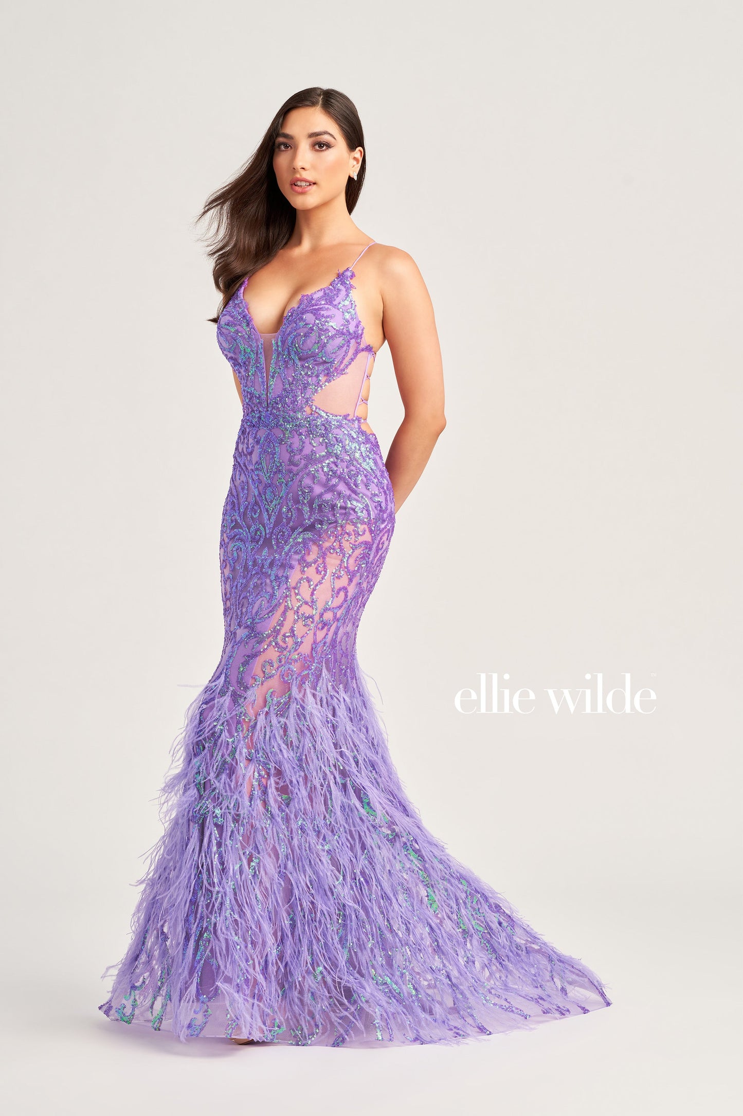 The Ellie Wilde EW35006 Sheer Sequin Prom Dress Gown features a low lace-up back with a side waist mesh inset corset and a glamorous, full-length feather skirt. Look stunning on your special night with this luxurious backless gown.  COLOR: ORANGE, CHAMPAGNE, EMERALD, HOT PINK, IRIS SIZE: 00 - 16