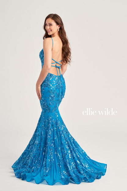 The Ellie Wilde EW35011 Long Mermaid Prom Dress features an eye-catching sequin tulle fabric, a flattering V-neckline, and a unique side waist cut out for a figure-hugging, yet comfortable fit. This gown also includes a lace-up back and a natural waistline for a dazzling and memorable look.  COLOR: BLACK, RED, LIGHT BLUE, EMERALD, LAVENDER, HOT PINK, DUSK, CERULEAN BLUE SIZE: 00 - 16