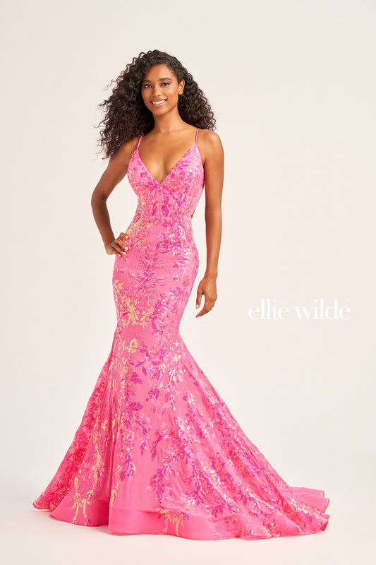 The Ellie Wilde EW35011 Long Mermaid Prom Dress features an eye-catching sequin tulle fabric, a flattering V-neckline, and a unique side waist cut out for a figure-hugging, yet comfortable fit. This gown also includes a lace-up back and a natural waistline for a dazzling and memorable look.  COLOR: BLACK, RED, LIGHT BLUE, EMERALD, LAVENDER, HOT PINK, DUSK, CERULEAN BLUE SIZE: 00 - 16