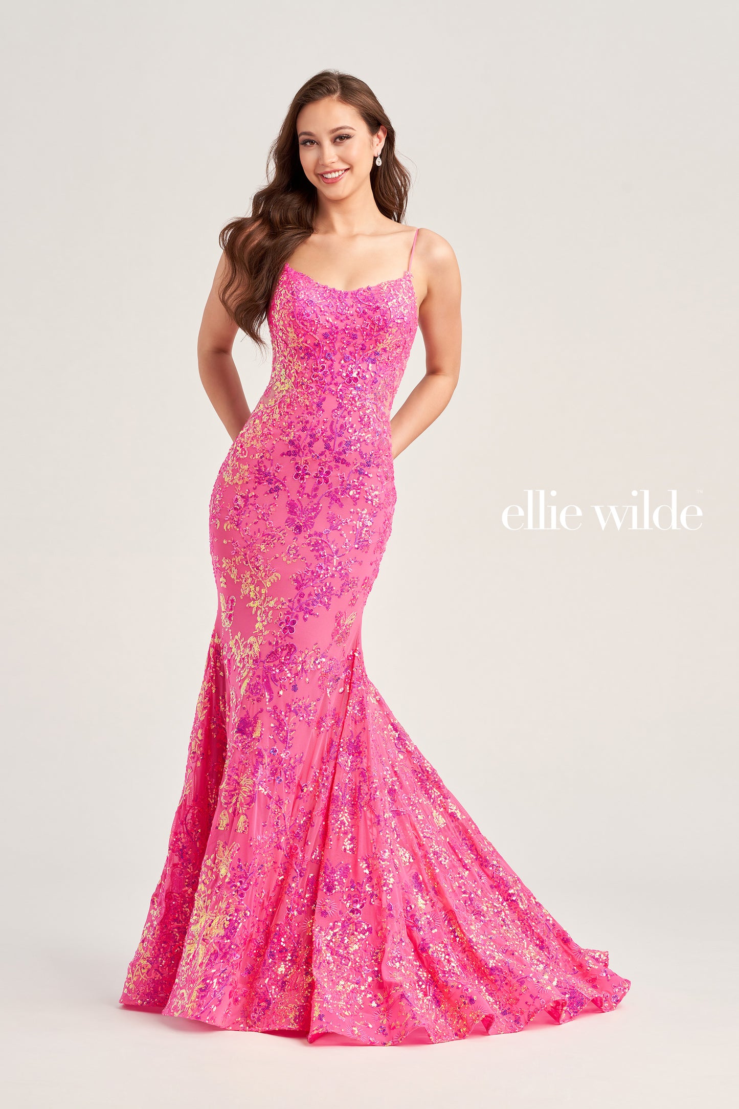 The Ellie Wilde EW35015 is a unique showstopper, featuring a fitted sequin stretch mesh fabric with a long length, scoop neckline, mermaid silhouette, sleeveless design, open back and natural waistline. Perfect for pageants, prom or any special occasion.  COLOR: MIDNIGHT, LIGHT BLUE, LILAC, HOT PINK SIZE: 00 - 16