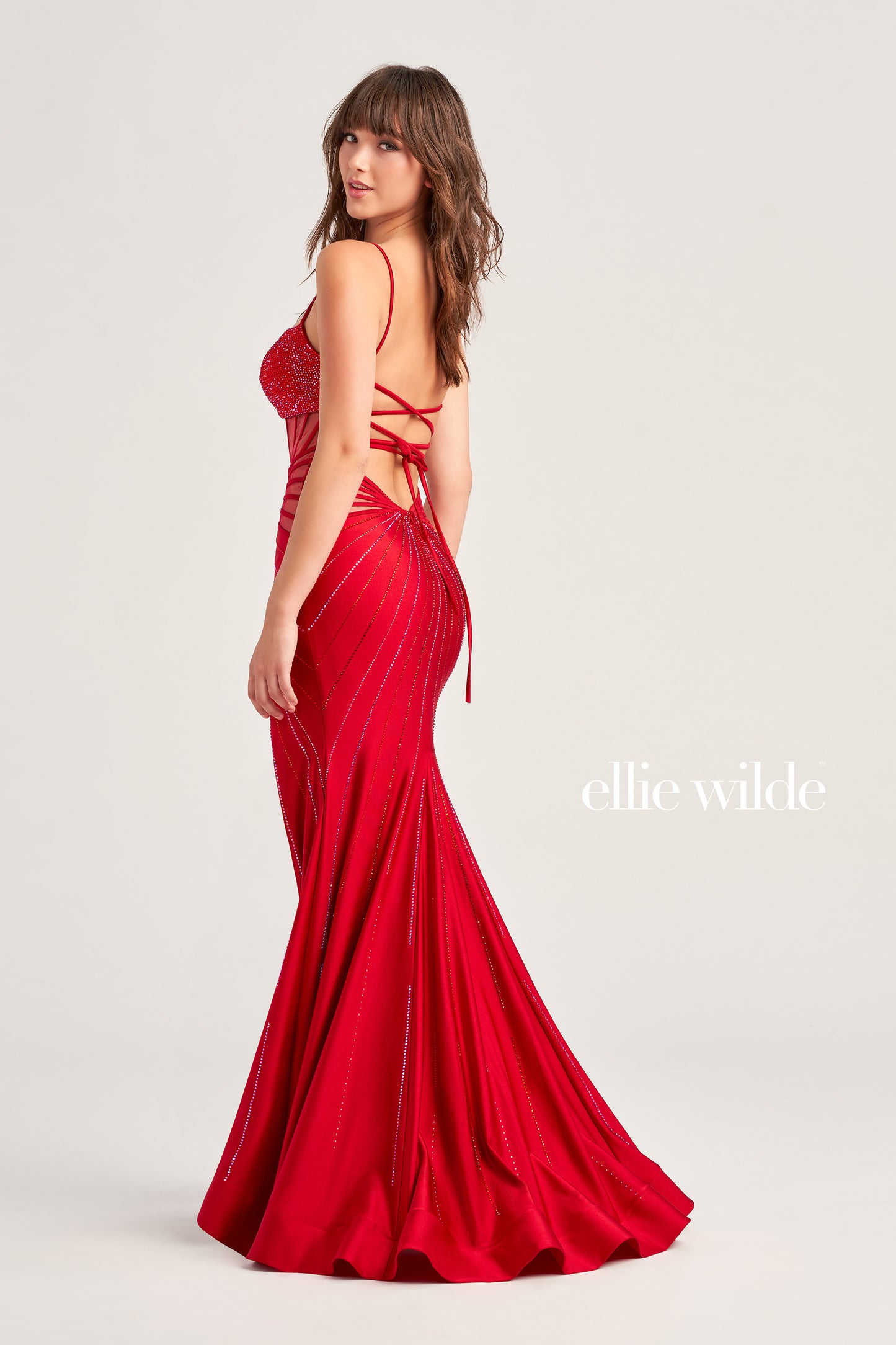 The Ellie Wilde EW35026 Prom Dress is an exquisite choice for any formal occasion. Crafted from jersey fabric with shining stone accents, it features a sweetheart neckline, fit and flare silhouette, and corset sheer bodice. A high slit and lace-up low back complete the look. Perfect for any memorable night.  COLOR: BLACK, ROYAL BLUE, HOT PINK, RUBY SIZE: 00 - 16