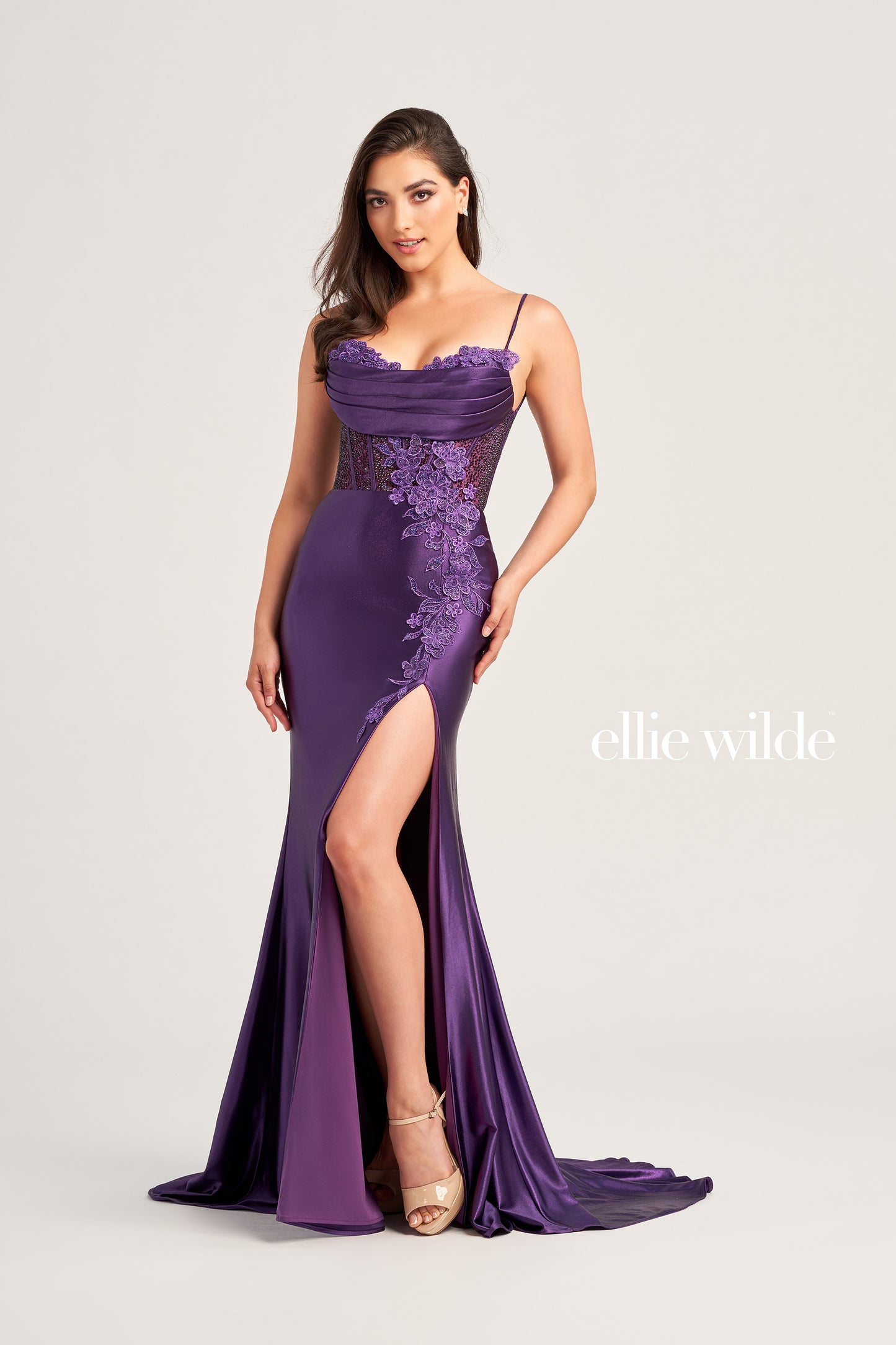 Look and feel your best in the Ellie Wilde EW35028 Long Sheer Corset Lace Formal Dress. This ultra-flattering evening gown features an alluring sweetheart neckline with lace choker detail, corset bodice, and a fit and flare silhouette, enhanced by lace appliques and stone accents. The luxe stretch satin jersey drapes effortlessly and the high slit adds movement and depth. Dazzle them with your entrancing look and effortless style.  COLOR: BLACK, RED, EMERALD, DARK PURPLE SIZE: 00 - 20