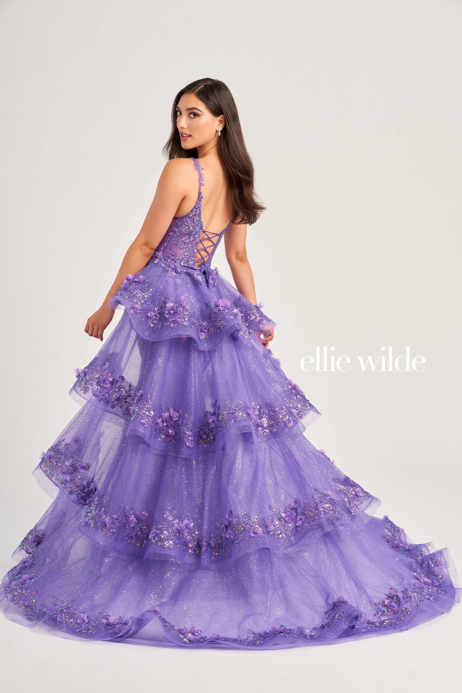 Look and feel your best in the Ellie Wilde EW35045 Prom Dress. This stunning piece features a sheer corset bodice with sequin and 3D Floral Lace accents, a detachable layered  train, three-dimensional flowers, and a glitter tulle skirt. The dress is constructed with cracked ice, sequin, and delicate lace-up back for a truly memorable look.  COLOR: LIGHT BLUE, MAGENTA, LILAC, IRIS SIZE: 00 - 16