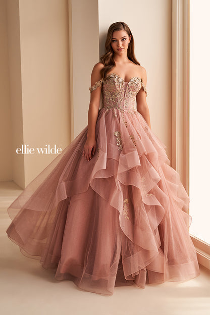 Make a statement in the Ellie Wilde EW35084 prom dress. Featuring an off-the-shoulder top, shimmer sequin lace and ruffle detail, the dress offers a timeless and sophisticated look perfect for the big night. Keep it classic in this classic formal gown.

Sizes: 00-24

Colors: Bluebell, Diamond White, Dusty Rose/Gold, Emerald, Hot Pink, Lavender, Light Pink, Light Yellow, Navy, Red, Royal, Silver, Teal, Wine&nbsp;
