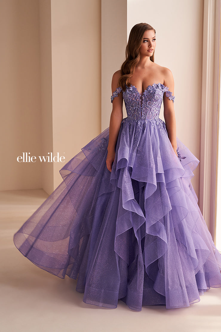 Make a statement in the Ellie Wilde EW35084 prom dress. Featuring an off-the-shoulder top, shimmer sequin lace and ruffle detail, the dress offers a timeless and sophisticated look perfect for the big night. Keep it classic in this classic formal gown.

Sizes: 00-24

Colors: Bluebell, Diamond White, Dusty Rose/Gold, Emerald, Hot Pink, Lavender, Light Pink, Light Yellow, Navy, Red, Royal, Silver, Teal, Wine&nbsp;