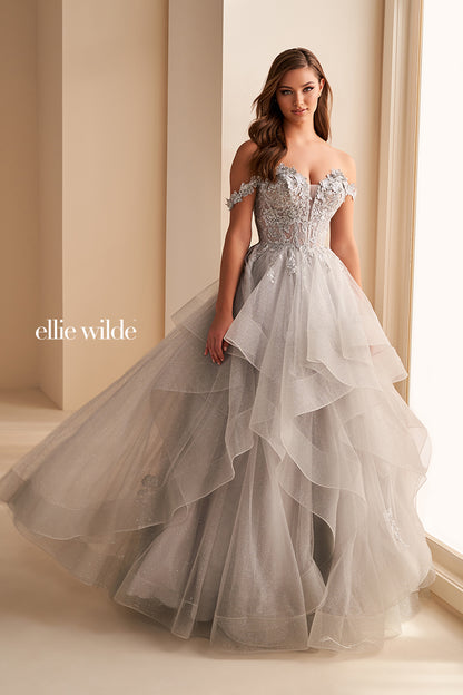 Make a statement in the Ellie Wilde EW35084 prom dress. Featuring an off-the-shoulder top, shimmer sequin lace and ruffle detail, the dress offers a timeless and sophisticated look perfect for the big night. Keep it classic in this classic formal gown.

Sizes: 00-24

Colors: Bluebell, Diamond White, Dusty Rose/Gold, Emerald, Hot Pink, Lavender, Light Pink, Light Yellow, Navy, Red, Royal, Silver, Teal, Wine&nbsp;
