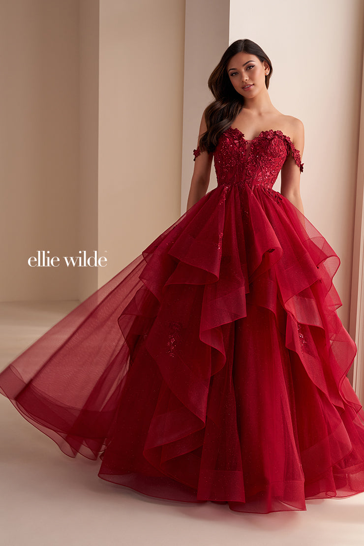 Make a statement in the Ellie Wilde EW35084 prom dress. Featuring an off-the-shoulder top, shimmer sequin lace and ruffle detail, the dress offers a timeless and sophisticated look perfect for the big night. Keep it classic in this classic formal gown.

Sizes: 00-24

Colors: Bluebell, Diamond White, Dusty Rose/Gold, Emerald, Hot Pink, Lavender, Light Pink, Light Yellow, Navy, Red, Royal, Silver, Teal, Wine&nbsp;