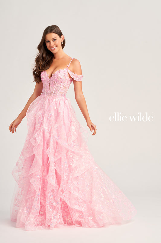 This Ellie Wilde EW35218 prom dress is a show-stopper. It features a sheer corset bodice with stone accents, lace appliques, and sequins. The detachable draped off-shoulder straps perfectly match the plunging sweetheart neckline. A-line silhouette in a long cracked ice tulle skirt adds to its timeless elegance. Make your grand entrance and shine the night away.  COLOR: BLACK, PINK, EMERALD, NAVY, WHITE