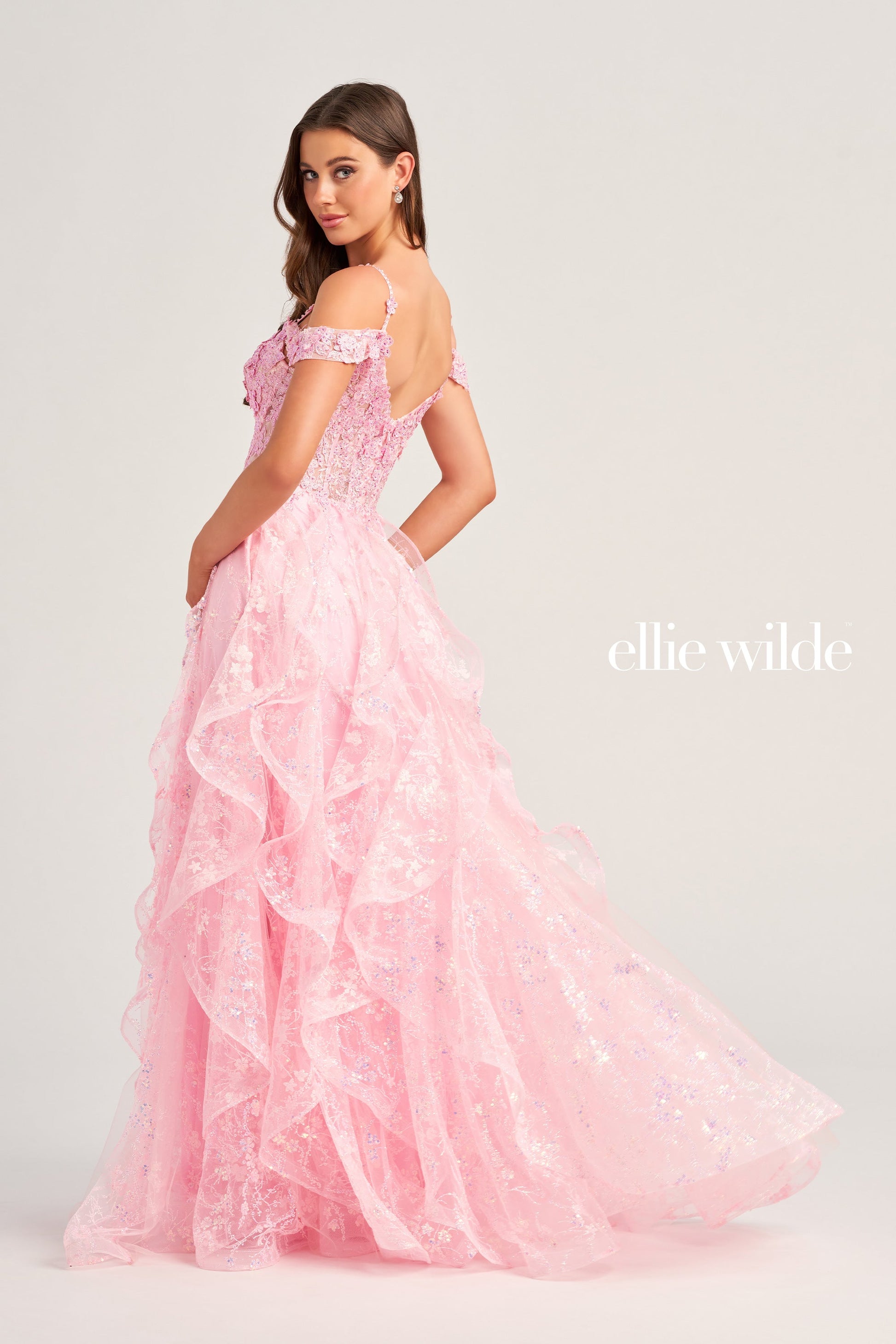 This Ellie Wilde EW35218 prom dress is a show-stopper. It features a sheer corset bodice with stone accents, lace appliques, and sequins. The detachable draped off-shoulder straps perfectly match the plunging sweetheart neckline. A-line silhouette in a long cracked ice tulle skirt adds to its timeless elegance. Make your grand entrance and shine the night away.  COLOR: BLACK, PINK, EMERALD, NAVY, WHITE