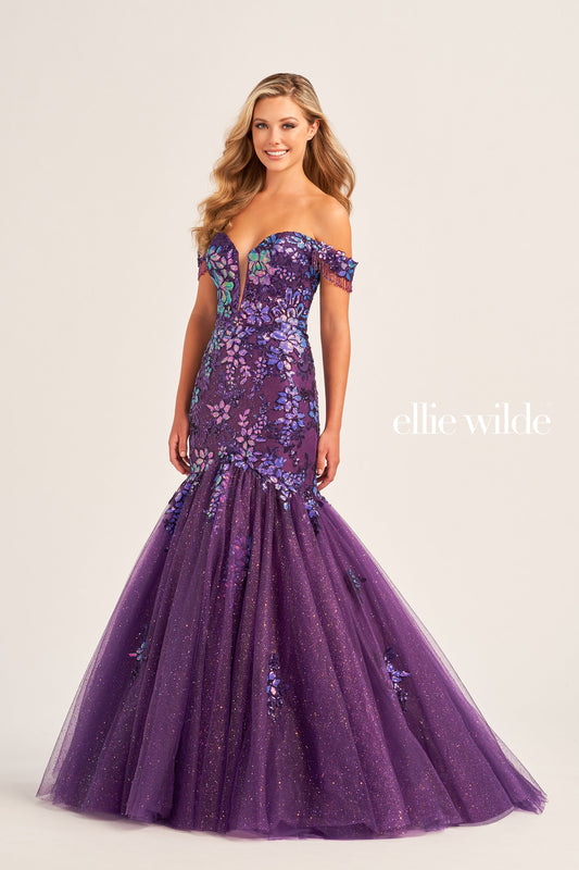 This stunning Ellie Wilde EW35219 Long Shimmer Sequin Mermaid Dress will make you stand out at any special occasion. Crafted with glitter tulle fabric and sequin appliqué, the eye-catching off the shoulder fringe adds a unique touch to the plunging sweetheart neckline and corset bodice. The luxurious lace-up back and natural waistline ensures the perfect fit.  COLOR: OCEAN BLUE, DARK PURPLE, LILAC SIZE: 00 - 16