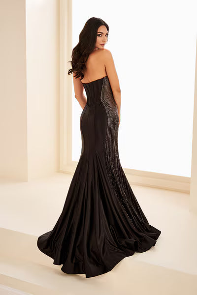 Ellie Wilde's EW37010 delivers sophisticated elegance with its fitted silhouette and strategic sheer cutout details. This stunning prom gown features intricate beading that catches the light beautifully, while the high slit adds modern movement and allure. The expertly tailored design flatters the figure, making it an ideal choice for those seeking a show-stopping formal look that balances glamour with contemporary style.

Sizes: 00-24

Colors: Black, Red, Yellow, Sakura Pink