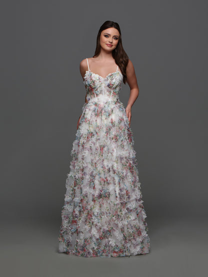 Experience elegance and grace with the Davinci F145 Floral Print Prom Dress. The stunning puff sleeves and A-line silhouette enhance your natural beauty while the sheer corset and shimmering pleats create a dreamy and ethereal look.