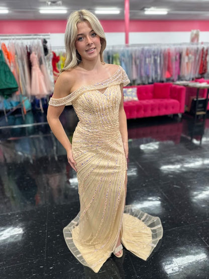 The Nox Anabel H1669 in size 4 is a meticulously crafted champagne-colored gown designed for formal occasions. Its long, fitted silhouette is enhanced by detailed beadwork and sequins, offering a refined shimmer that catches the light elegantly. The gown features a sophisticated slit, providing both movement and subtle allure. A standout element is the detachable asymmetrical off-the-shoulder cape sleeve, which adds versatility and a modern edge to the classic design. This dress combines expert tailoring wi