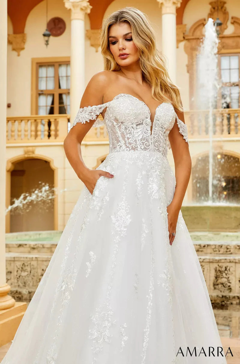 Amarra Bridal 84373 "Hannah" A-Line Ballgown Off The Shoulder Deep V-Neck Corset Train Wedding Gown.Featuring fancy detachable shoulder straps and a deep-v neckline, Hannah is a beauty that’s bound to have all eyes on you. This ball-gown like wedding dress features a dramatic skirt that pools at the bottom, creating a beautiful sweep train with every step.