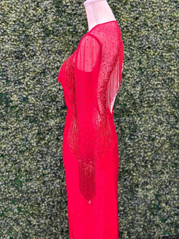 The Johnathan Kayne 2795 Size 4 Crystal Sheer Beaded Fringe Long Sleeve Cocktail Dress is crafted from Satin shimmer fabric and features a sheer beaded fringe design. one long sleeve with fringe and crystal accents. This sophisticated take on a classic dress is sure to delight with its delicate elegance. Asymmetrical skirt.  * ONE OF A KIND  Size: 4  Color: Red