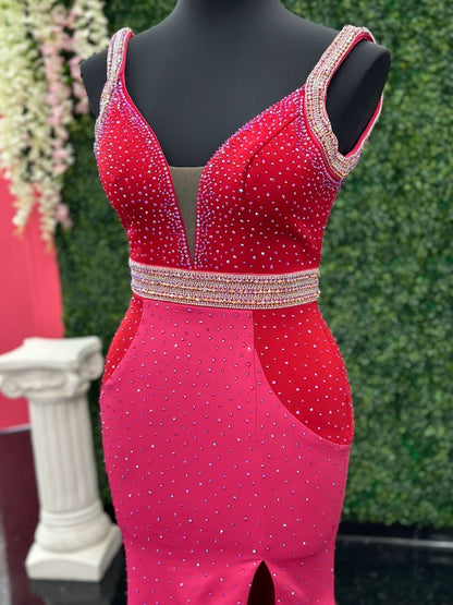 The Johnathan Kayne 2628 is a glamorous pageant dress, crafted from fitted scuba for a sleek and form-flattering effect. The gown features a crystal accented waist line, shoulder straps and v neckline with scattered crystals and glittering accents, making it perfect for special occasions. With its comfortable fit and elegant design, this size 4 dress adds sparkle to any ensemble. Color Block Combo.  *Theses are ONE OF A KIND!  Size: 4  Color: Red/Fuchsia