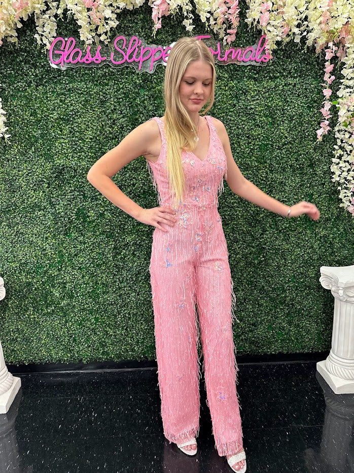 This Johnathan Kayne 31594 Jumpsuit is the perfect formalwear for special occasions. Crafted from shimmering sequin lace and delicately embellished with fringe, this size 4 pink jumpsuit is sure to turn heads.  * ONE OF A KIND  Size: 4  Color: Pink