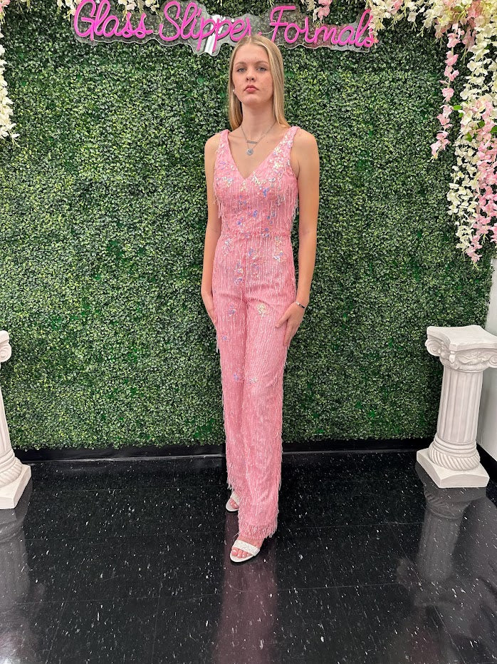This Johnathan Kayne 31594 Jumpsuit is the perfect formalwear for special occasions. Crafted from shimmering sequin lace and delicately embellished with fringe, this size 4 pink jumpsuit is sure to turn heads.  * ONE OF A KIND  Size: 4  Color: Pink