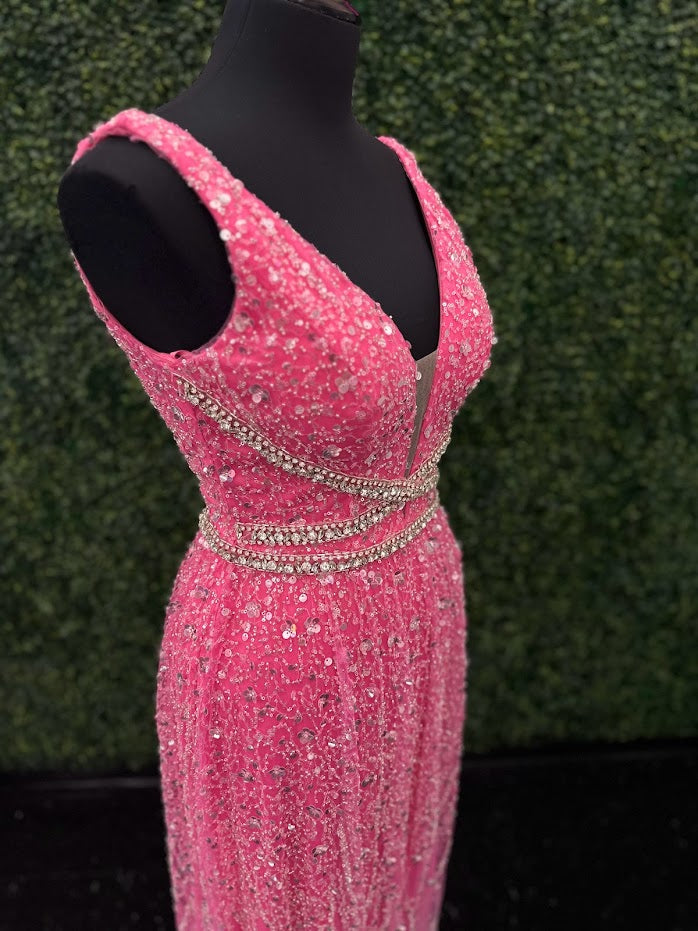 Look stunning in the Johnathan Kayne 5400 dress. This formal gown features a V-neckline, bead and sequin embellishments, and crystal accents all over for a truly show-stopping look. The A-line silhouette will flatter all body types and ensure you remain comfortable throughout the evening.  *ONE OF A KIND  Size: 4  Color: Pink