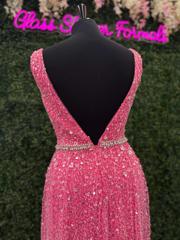 Look stunning in the Johnathan Kayne 5400 dress. This formal gown features a V-neckline, bead and sequin embellishments, and crystal accents all over for a truly show-stopping look. The A-line silhouette will flatter all body types and ensure you remain comfortable throughout the evening.  *ONE OF A KIND  Size: 4  Color: Pink
