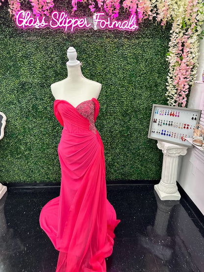 The Lucci Lu 1348 Pageant Dress is a stunning style for any special occasion. It features a fuchsia corset wrap, off the shoulder design that softly drapes around the back of the arms.  slit skirt with a chiffon overskirt. This size 4 dress will surely make you stand out. boning in corset style bodice with detailed beading and crystals  Size: 4  Color: Fuchsia