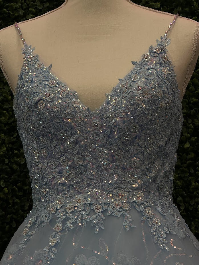 This Blue Sequin Lace Shimmer Ballgown by Johnathan Kayne features high quality sequin detailing on the bodice and skirt to create a dramatic and eye-catching look. The sleeveless bodice has a modest neckline, while the floor-length skirt adds elegance and movement for the perfect prom dress. 3d Floral Tulle Appliques and sequins cascading down the skirt.  *** One of A KIND!  Size: 4  Color: Light Blue